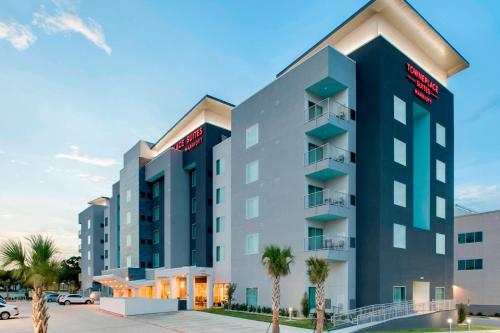 a rendering of a hotel with palm trees in front at TownePlace Suites Fort Worth University Area/Medical Center in Fort Worth