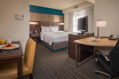 a hotel room with a bed and a desk and a tv at Residence Inn Arlington Rosslyn in Arlington