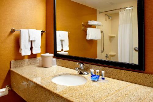 a bathroom with a sink and a mirror and towels at Fairfield Inn & Suites Parsippany in Parsippany