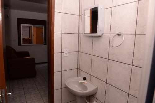 a bathroom with a toilet and a sink at Apto completo e aconchegante em Santa Rosa RS in Santa Rosa