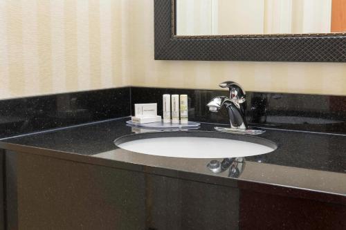 a bathroom counter with a sink and a mirror at Fairfield Inn & Suites Fargo in Fargo