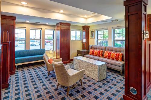a living room with a couch and a table and chairs at Residence Inn Minneapolis Plymouth in Plymouth