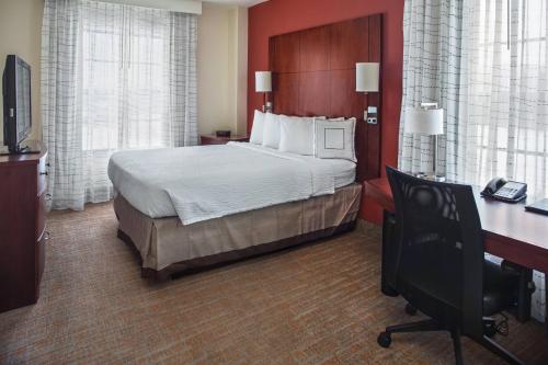 a hotel room with a bed and a desk with a computer at Residence Inn Aberdeen at Ripken Stadium in Aberdeen