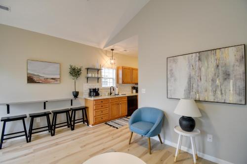 a kitchen with a blue chair and a table at Walk to Ocean Myrtle Beach Home with Pool Access in Myrtle Beach