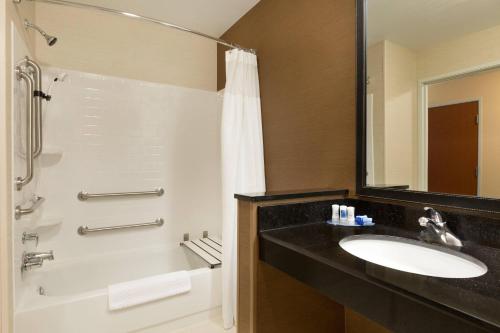 a bathroom with a sink and a tub and a shower at Fairfield Inn & Suites Bismarck South in Bismarck