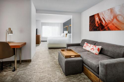 a living room with a couch and a bed at SpringHill Suites Providence West Warwick in West Warwick