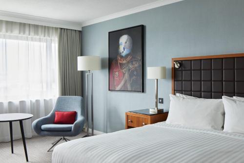 a hotel room with a bed and a chair at Portsmouth Marriott Hotel in Portsmouth