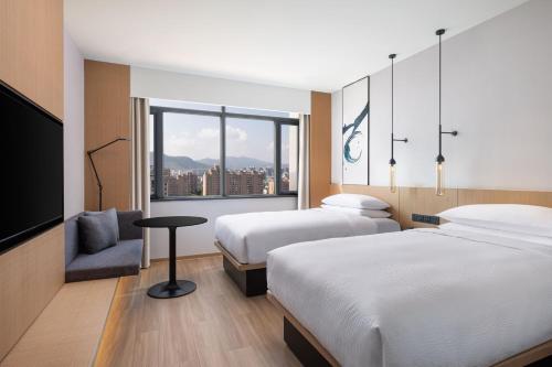 a hotel room with two beds and a window at Fairfield by Marriott Hangzhou Xihu District in Hangzhou