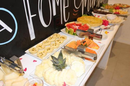 a buffet table with many different types of food at Villa dos Graffitis Pousada in Morro de São Paulo
