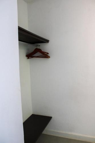 a shelf in a room with a white wall at Villa dos Graffitis Pousada in Morro de São Paulo