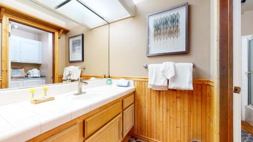 a bathroom with a sink and a mirror at Aspen Creek #227 condo in Mammoth Lakes