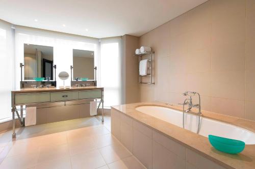 a large bathroom with a tub and a sink at The Westin Melbourne in Melbourne