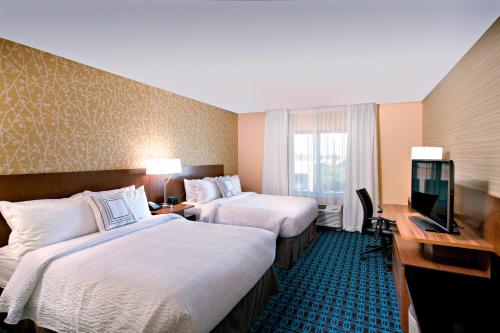 a hotel room with two beds and a flat screen tv at Fairfield Inn & Suites by Marriott Phoenix Tempe/Airport in Tempe