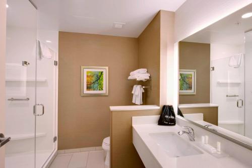 a bathroom with a sink and a shower and a toilet at Fairfield Inn & Suites by Marriott Phoenix Tempe/Airport in Tempe