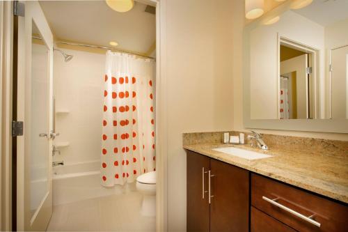 a bathroom with a sink and a toilet and a mirror at TownePlace Suites by Marriott Eagle Pass in Eagle Pass