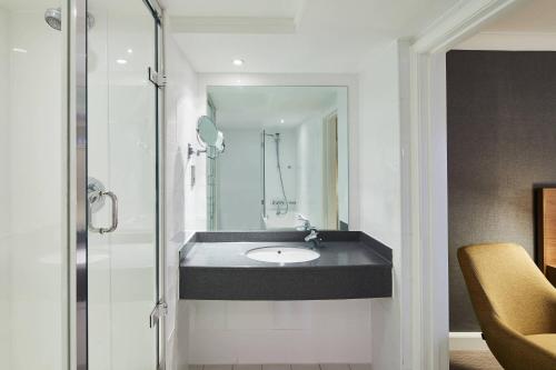 a bathroom with a sink and a mirror at Cardiff Marriott Hotel in Cardiff