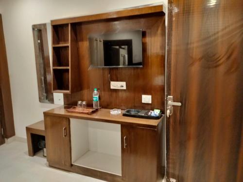 a bathroom with a wooden vanity with a mirror at StudioZ Paradise Hills Mussoorie in Mussoorie