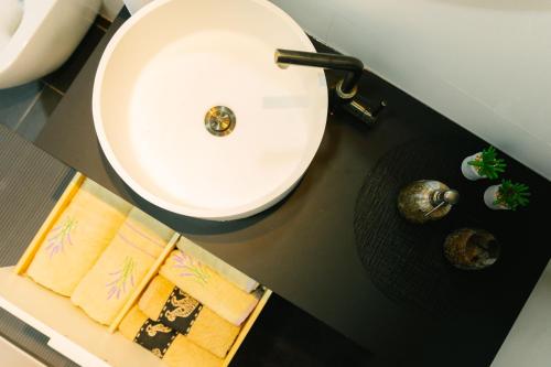 a bathroom with a sink and a white sink at Sarajevo Skyline Apartment in Sarajevo