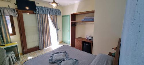 a room with a bed and a table in a room at La Locanda Del Fiordo in Furore