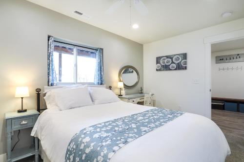 a bedroom with a large white bed and a window at Orem Vacation Rental Apartment Near BYU Campus! in Orem