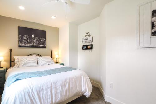a bedroom with a bed with white sheets at Orem Vacation Rental Apartment Near BYU Campus! in Orem