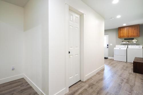 an empty living room with white walls and wooden floors at Orem Vacation Rental Apartment Near BYU Campus! in Orem