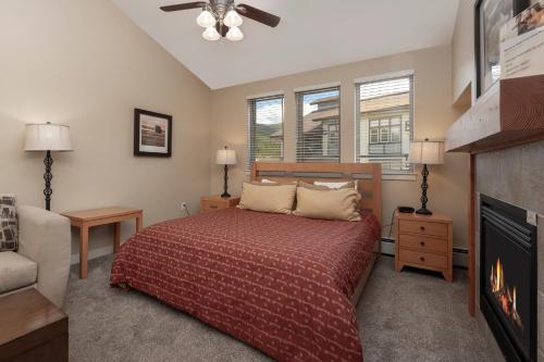 a bedroom with a bed and a fire place at Fraser Crossing Unit 3618 in Winter Park