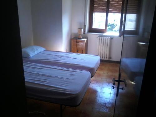 a small bedroom with two beds and a window at Tropea center room in Tropea