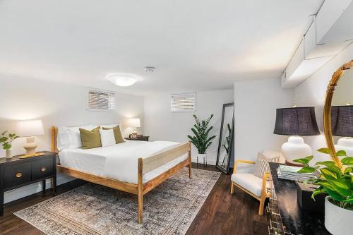 a bedroom with a bed and a couch and a chair at Lilac In Law, Picturesque lower unit in Seattle