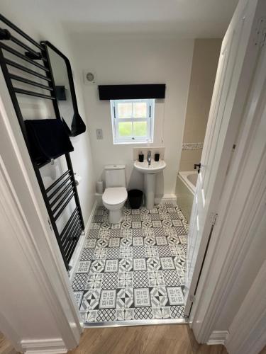 a small bathroom with a toilet and a sink at Sea-Haven on Sunrise Ground Floor Holiday Home The Bay Filey in Filey