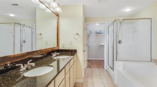 a bathroom with two sinks and a shower at Legacy II 1008 in Gulfport