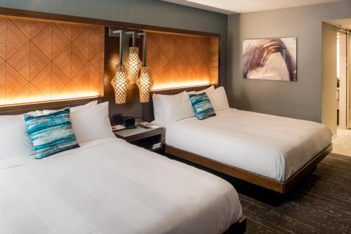a hotel room with two beds and a chandelier at Seattle Airport Marriott in SeaTac