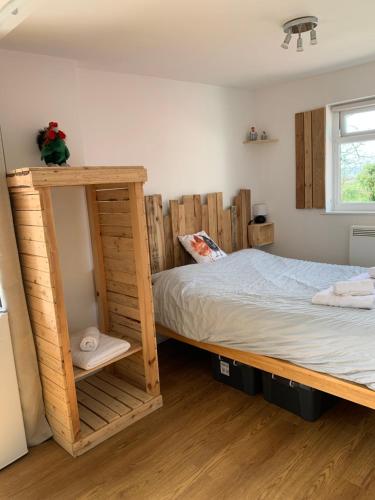 a bedroom with wooden bunk beds and a window at The Hen House in Bere Alston