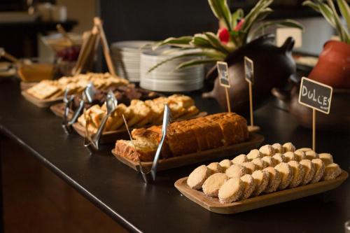 a buffet with several different types of bread and pastries at Hotel Club La Serena in La Serena