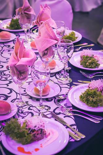 a table with plates of food and wine glasses at Hotel Club La Serena in La Serena