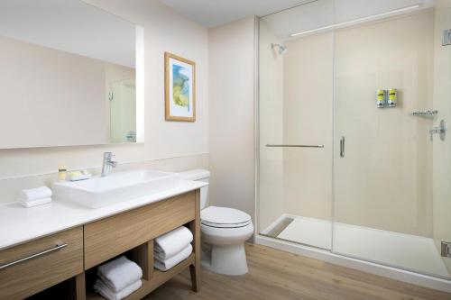 a bathroom with a sink and a toilet and a shower at Element Orlando Universal Blvd. in Orlando