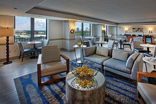 a hotel lobby with couches and tables and windows at Renaissance Fort Lauderdale Cruise Port Hotel in Fort Lauderdale