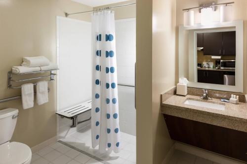 a bathroom with a toilet and a shower curtain at TownePlace Suites by Marriott Little Rock West in Little Rock