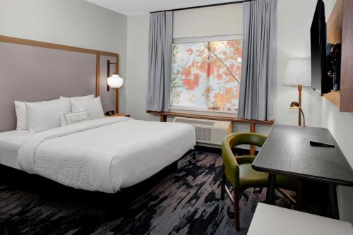 a hotel room with a bed and a desk and a window at Fairfield Inn & Suites by Marriott Roanoke Salem in Salem