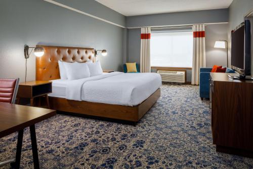 um quarto de hotel com uma cama e uma televisão em Four Points by Sheraton Louisville Airport em Louisville