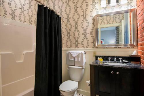 a bathroom with a toilet and a sink and a mirror at Fairfield Inn & Suites by Marriott Keene Downtown in Keene
