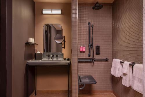 a bathroom with a sink and a mirror at Moxy Downtown Los Angeles in Los Angeles