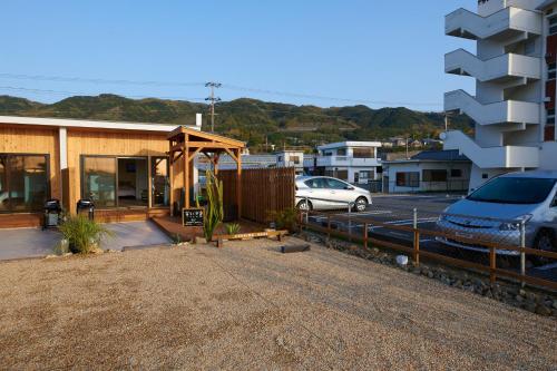 a house with a car parked in a parking lot at Rush Awaji - Seaside Holiday Home - Self Check-In Only in Awaji