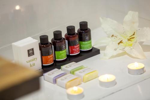 a counter with four bottles of essential oils and candles at Lyhnos in Askas