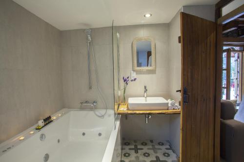 a bathroom with a bath tub and a sink at Lyhnos in Askas