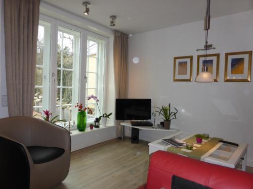 a living room with a red couch and a tv at Meeresleuchten in Lüneburg