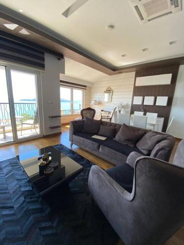 a living room with a couch and a table at Apartments Hana 2 in Pržno