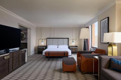 a hotel room with a bed and a television at JW Marriott Houston by the Galleria in Houston