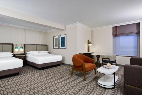 a hotel room with two beds and a table at JW Marriott Houston by the Galleria in Houston