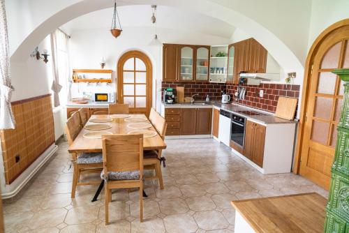 a kitchen with a table and chairs and a kitchen with an archway at Apartmány Močovice 